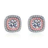 Pair of earrings with pink and clear moissanite gemstones on a white background